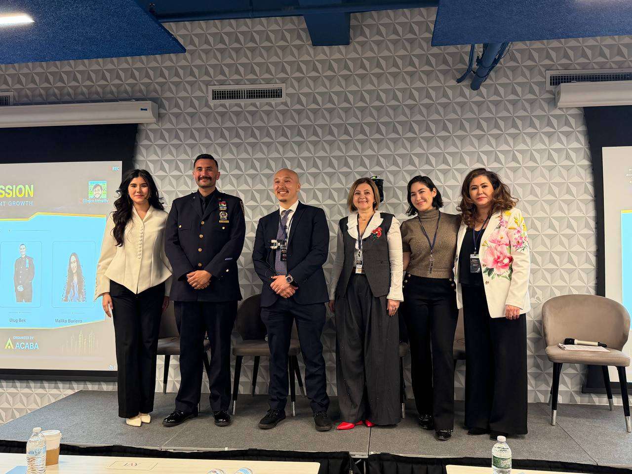 Panelists gathered on stage at a professional conference