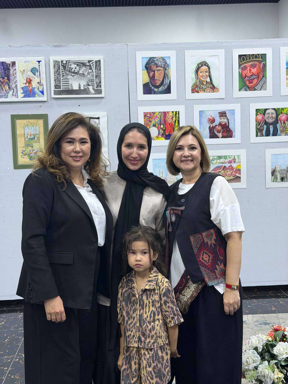 Guests with a child posing at an art exhibition