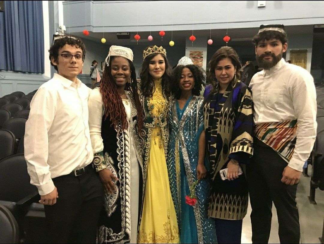 Guests in traditional dress gathered at an evening celebration