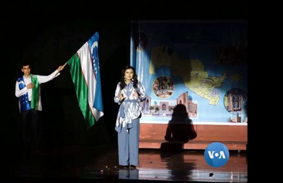 Performers in a dramatic scene on a darkened stage