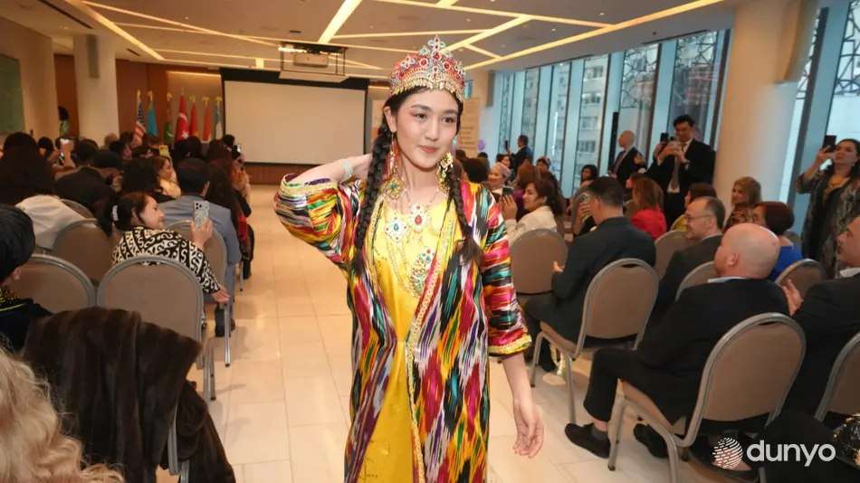 Model in an ikat gown walking past the audience at a fashion showcase