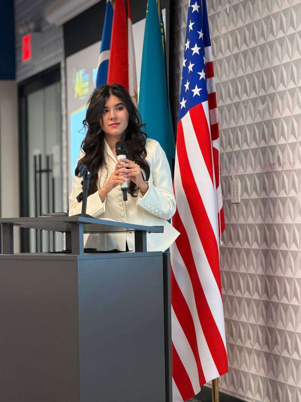 Speaker at a podium beside the flag of the United States