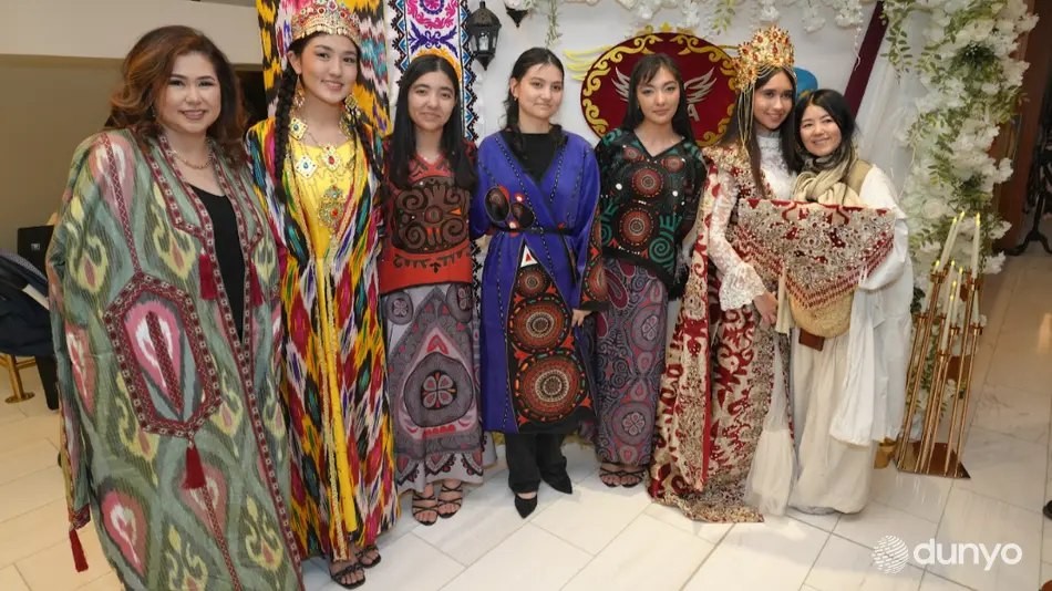 Women in colorful ikat gowns and headdresses at a cultural celebration
